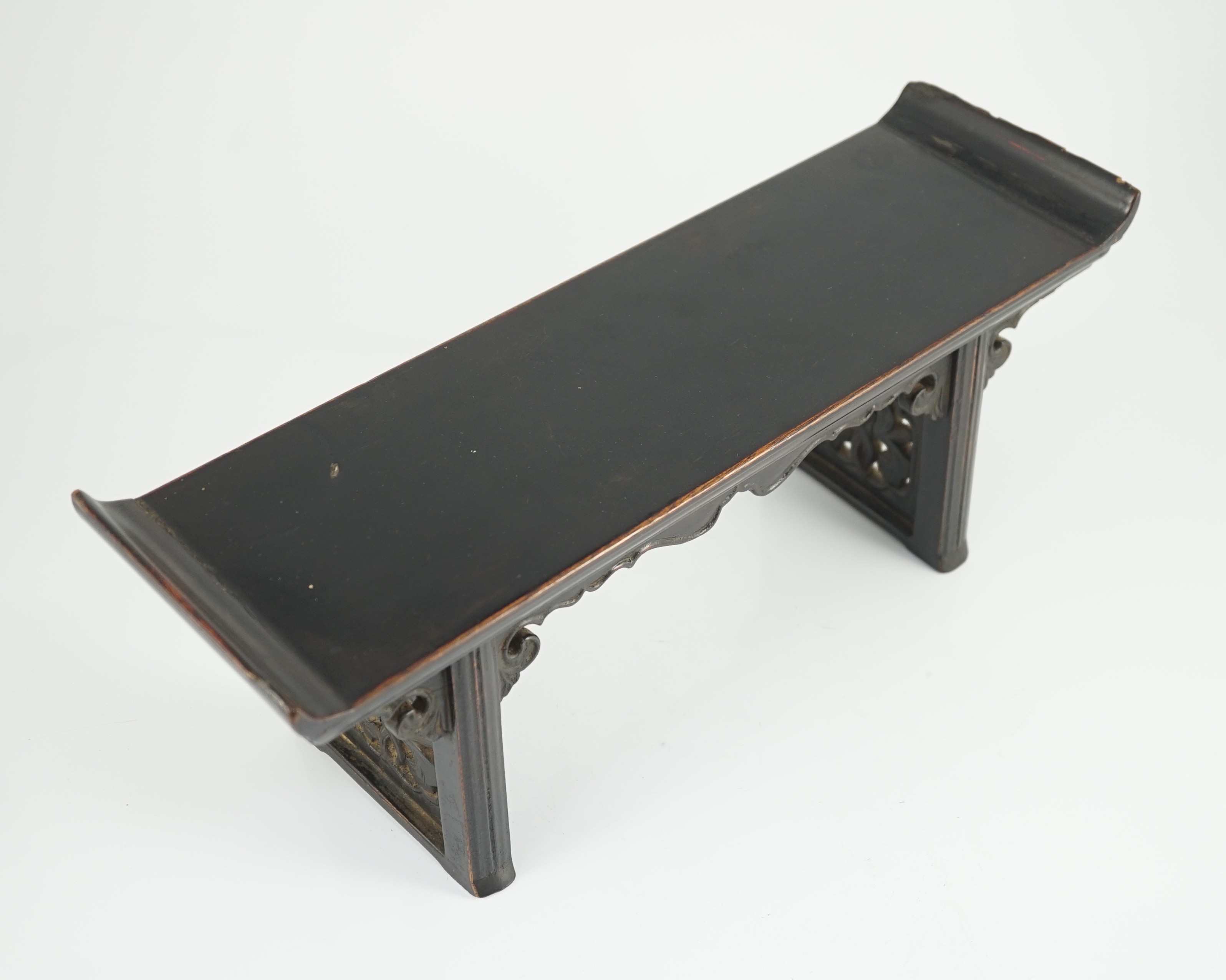 A Chinese late Ming lacquered wood model of an altar table, 17th century, 41cm wide, 16.5cm high, minor losses